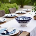Hand-painted ceramic bowl on outdoor table setting, blue floral design, artisan serving dish 9.8 inch