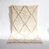Traditional Moroccan carpet with diamond geometric pattern in cream wool with dark brown lines and fringed edges