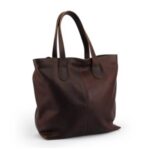 Brown leather tote bag angled view showing craftsmanship and reinforced stitching