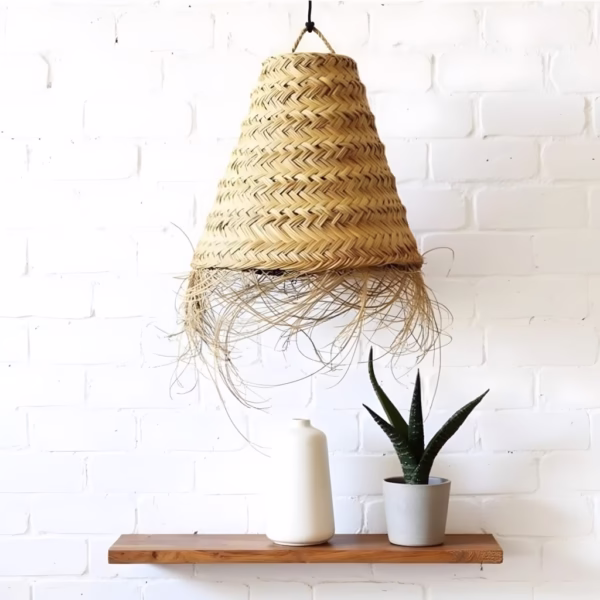 Single handwoven straw lamp against white brick wall with wooden shelf and plants