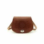 Embossed leather crossbody bag with handcrafted mandala design in cognac brown with adjustable tan strap