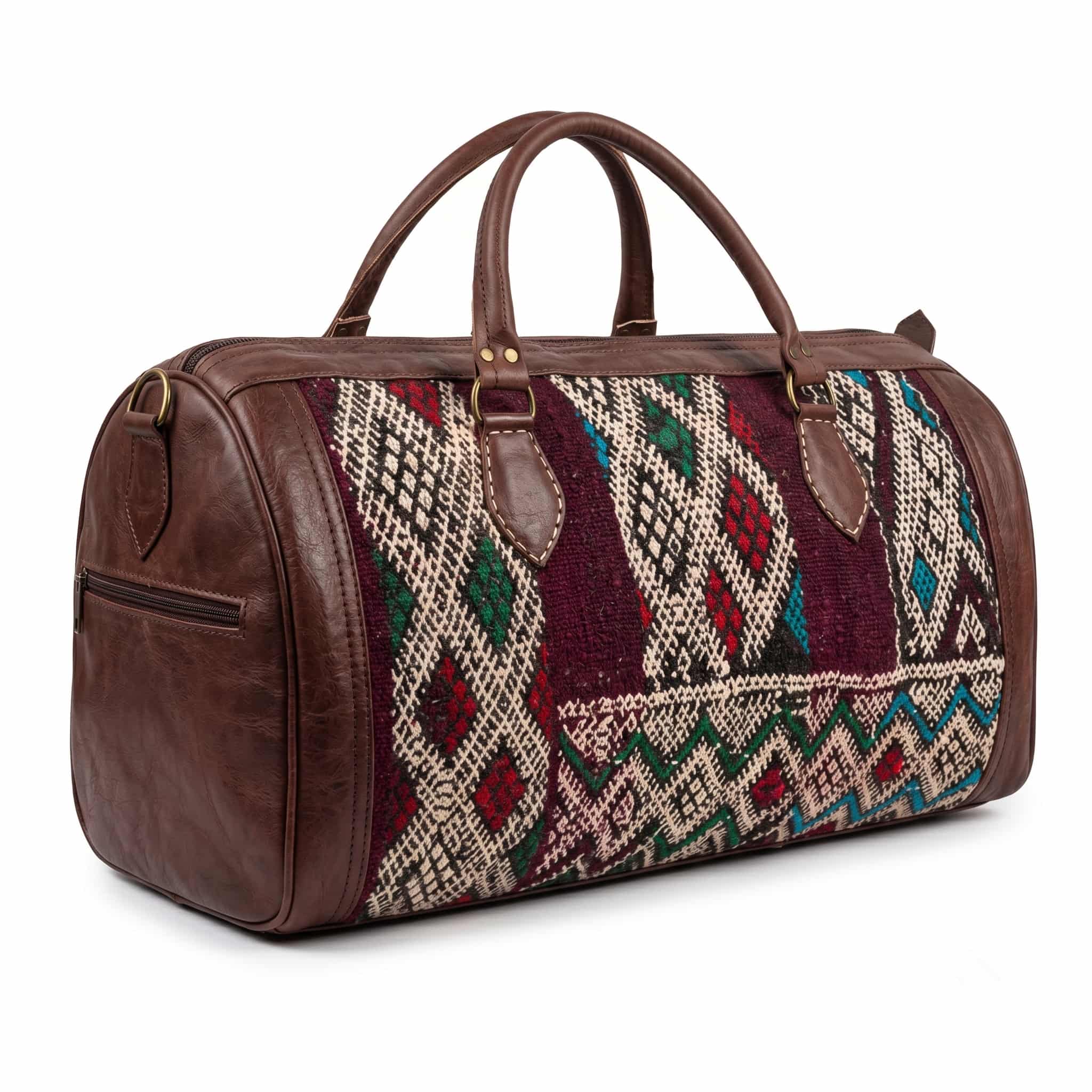 kilim-leather-duffle-bag-white-background Kilim leather duffle bag main product photo on white background with soft shadow, brown full-grain leather frame and handwoven wool center panel