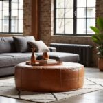 Round leather floor ottoman coffee table in industrial loft with brick walls and large windows