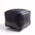 Square black leather pouf ottoman on white background
