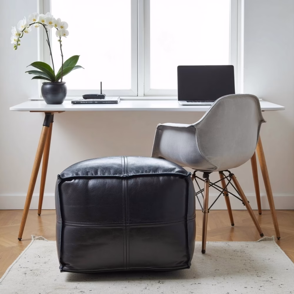 Black leather pouf with modern home office setup