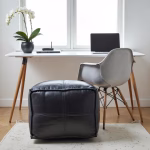 Black leather pouf with modern home office setup
