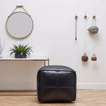 Black square pouf in contemporary living space