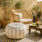 White leather floor ottoman round pouf in outdoor Moroccan patio setting with mosaic tile floor
