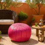 Pink leather round ottoman on outdoor patio with Moroccan tea set - handcrafted floor pouf with embroidery