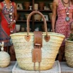 Leather straw tote with heart-shaped leather patches and braided handles at artisan market