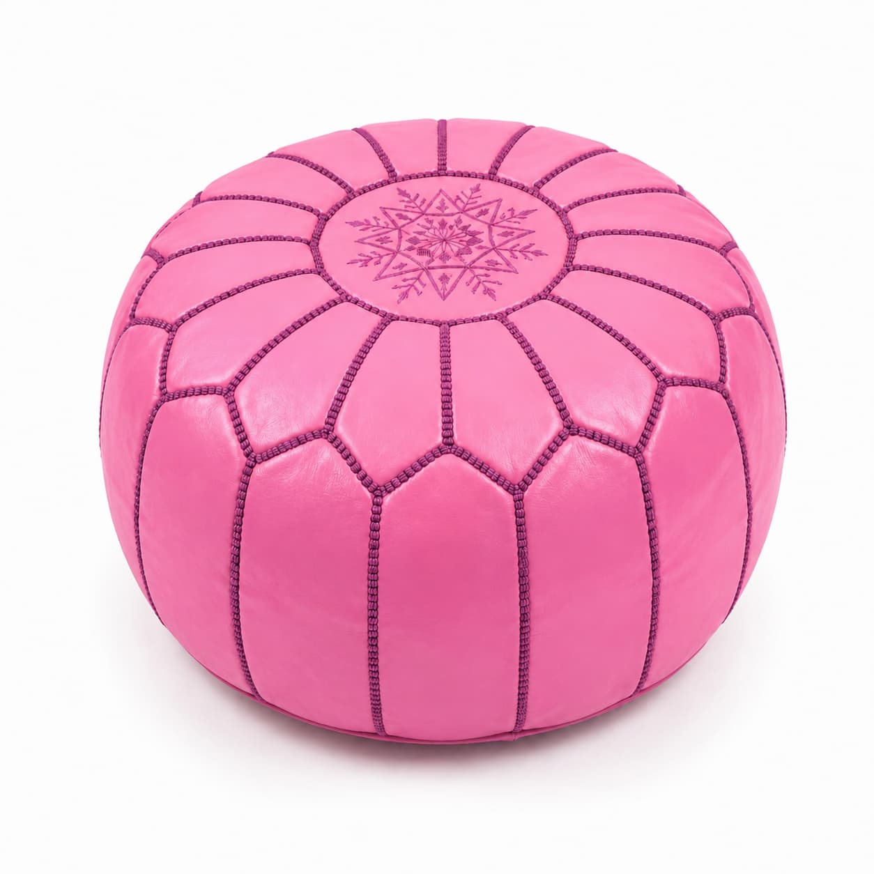 MCLPR04-pink-leather-round-ottoman-front-hero-image Vibrant pink leather round ottoman featuring traditional handcrafted patchwork goatskin and intricate embroidery on a white background.