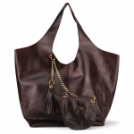 Product photo of handbag with matching wallet against white background