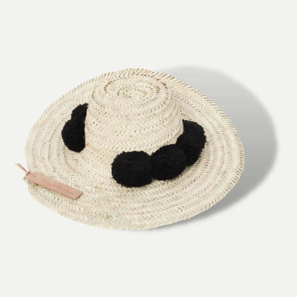 Handwoven straw beach hat with sky blue pompoms, wide brim Moroccan design with natural woven texture