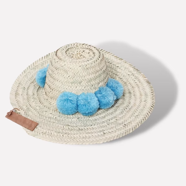 Straw beach hat with blue cotton pompom decoration