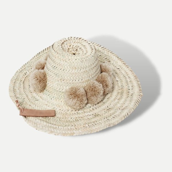 Handwoven straw beach hat with beige pompoms, natural wide brim Moroccan design with leather tag detail