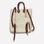Back view of straw backpack showing leather strap design on white background