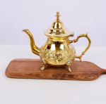 Detailed view of brass teapot lid and sugar bowl craftsmanship