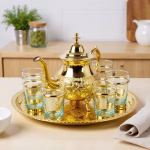 Close-up of hand-engraved brass teapot showing traditional Moroccan patterns