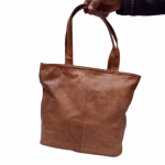 Brown woven leather handbag product shot against white background
