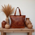 Handwoven leather tote bag with brown basketweave panel on windowsill with morning coffee