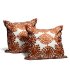 Burnt orange embroidered pillow covers set with floral medallion design on white cotton, handcrafted cushion covers