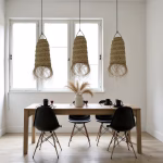 Triple hanging lamp shades over dining table