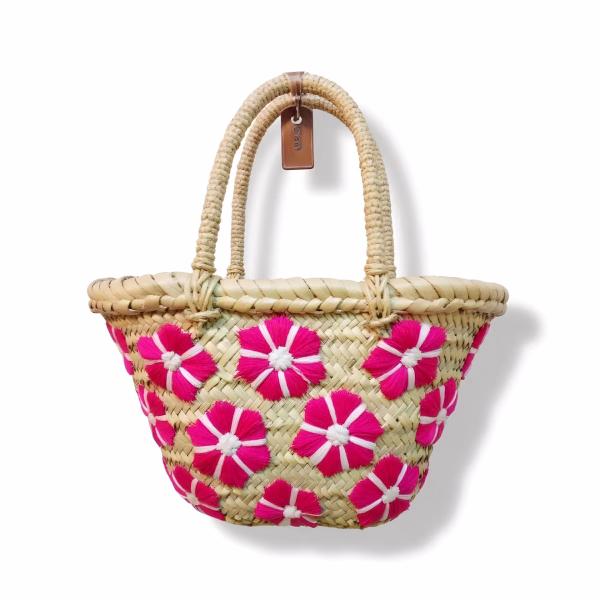 Pink floral small straw bag with daisy pattern on white background