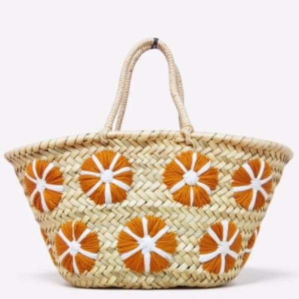 Small straw bag with orange floral embroidery on white background