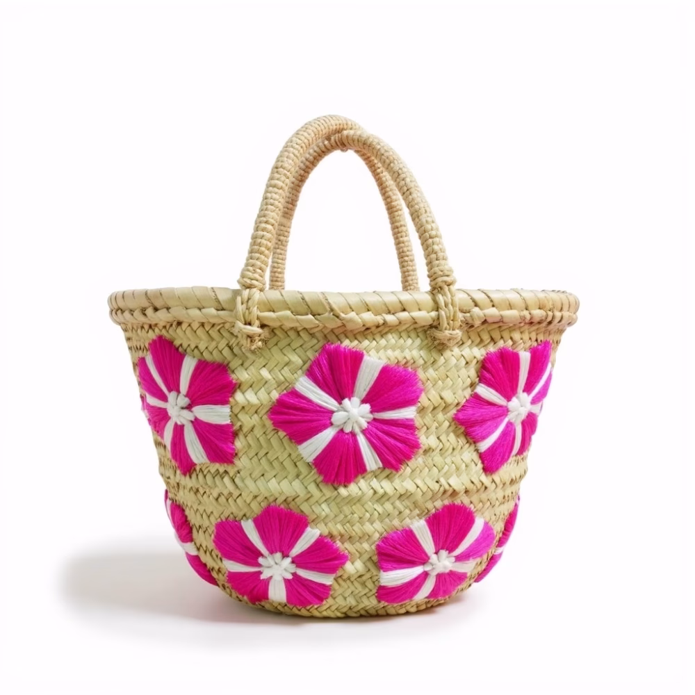 Front view of pink embroidered small straw bag with flower design