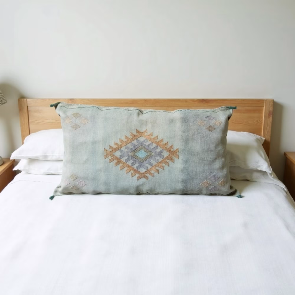 Lumbar silk cactus pillow cover styled on wooden headboard