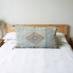 Lumbar silk cactus pillow cover styled on wooden headboard