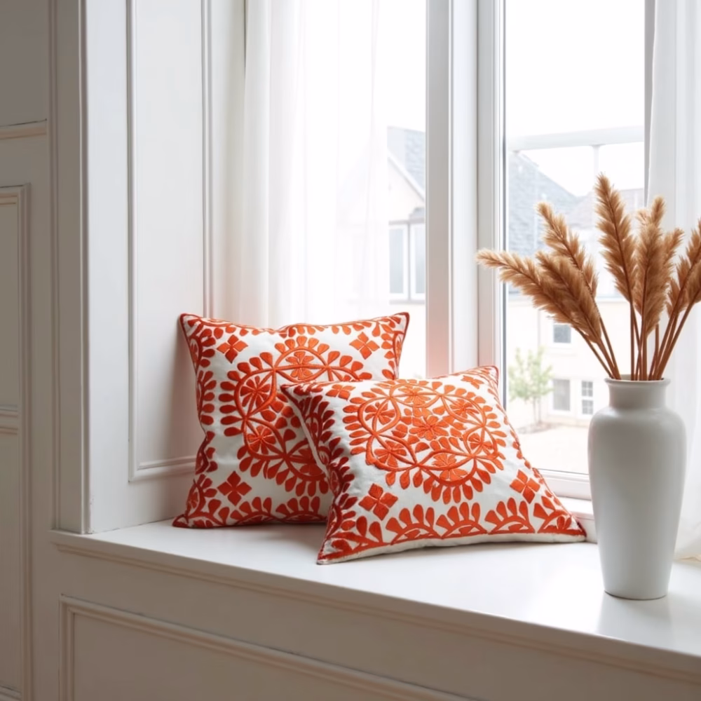 Orange damask cushions styled with dried pampas grass