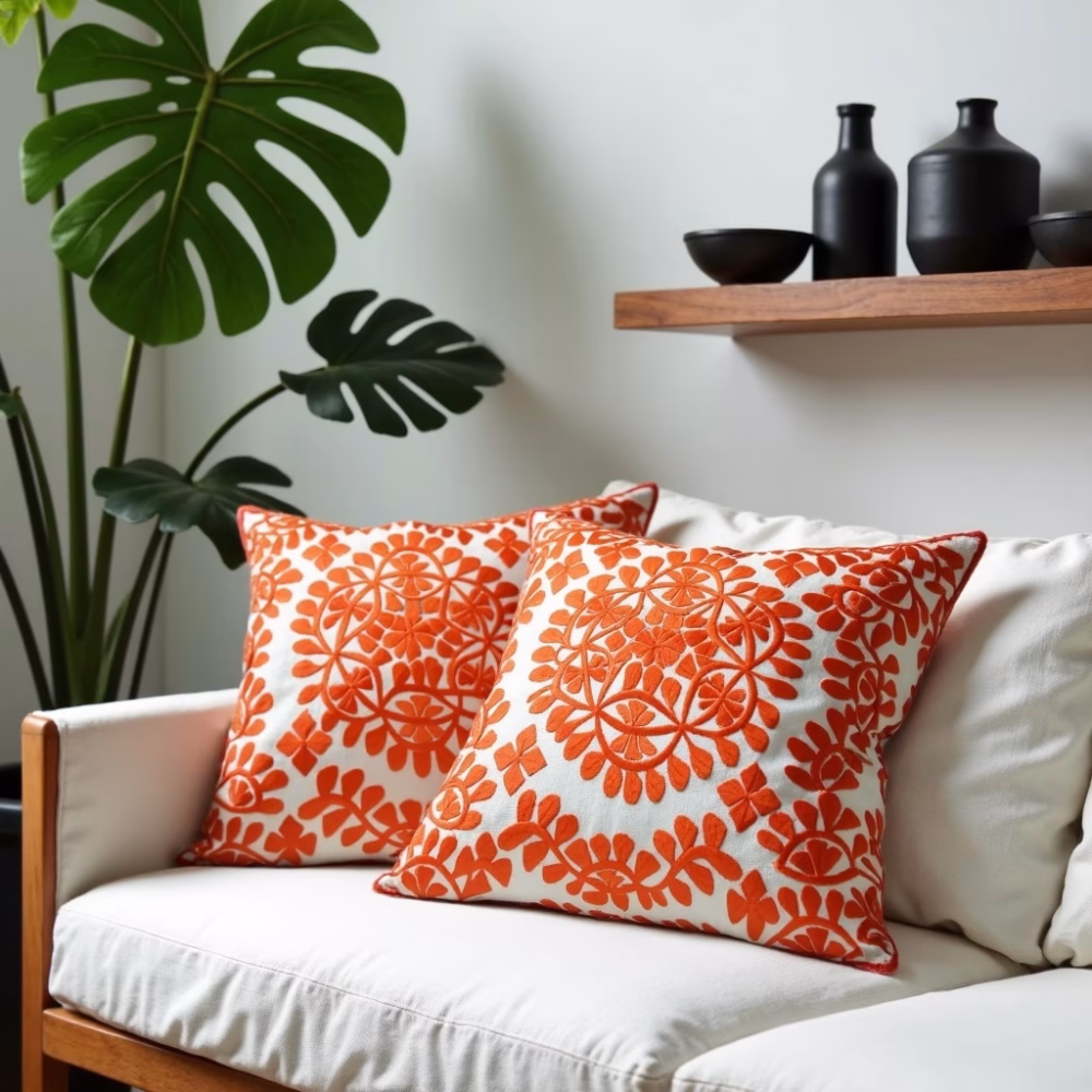Set of embroidered cushions on white sofa with tropical decor