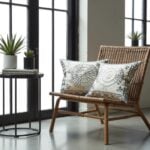 Embroidered cotton pillow covers with gray spiral design on wicker chair in modern living room setting