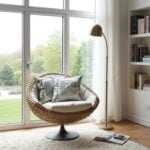 Luxury embroidered cotton pillow covers featuring spiral medallion in cozy wicker reading chair by window