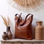 Artistic composition of leather hobo handbag with natural decor
