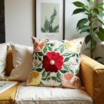 Handcrafted embroidered cotton pillow covers with colorful floral design on modern sofa with yellow accent