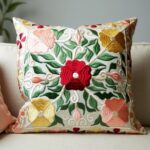 Close-up of embroidered cotton pillow covers showing detailed Suzani floral stitching and texture