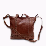Product shot showing shoulder strap of brown leather shopper bag