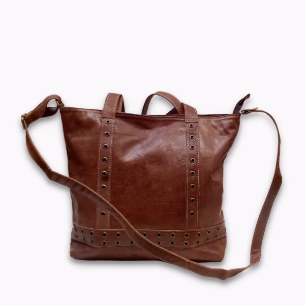 Product shot showing shoulder strap of brown leather shopper bag
