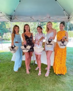 Group photo of bridesmaids with personalized mini straw bags
