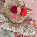 Custom mini straw bag with pink embroidery and matching pom poms