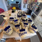 Collection of navy blue personalized mini straw bags for group event