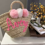 Pink personalized mini straw bag with pom poms and custom name