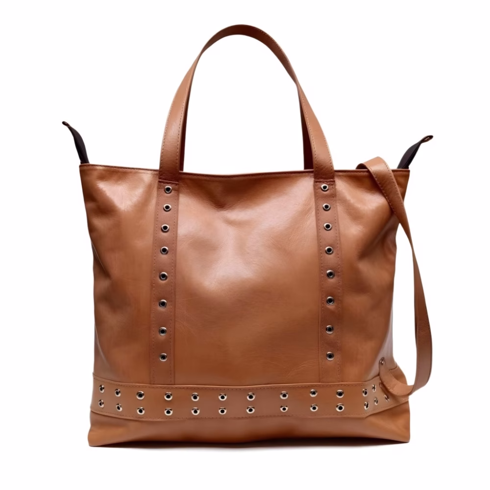 Tan leather shopper bag with studded detail against white background