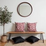 Red floral pillow covers displayed on wooden bench with mirror, burgundy decorative cushion covers in entryway