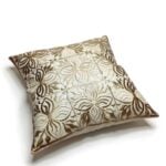 Premium leather pillow covers in beige with dimensional floral cutwork arranged flat showing detailed pattern view