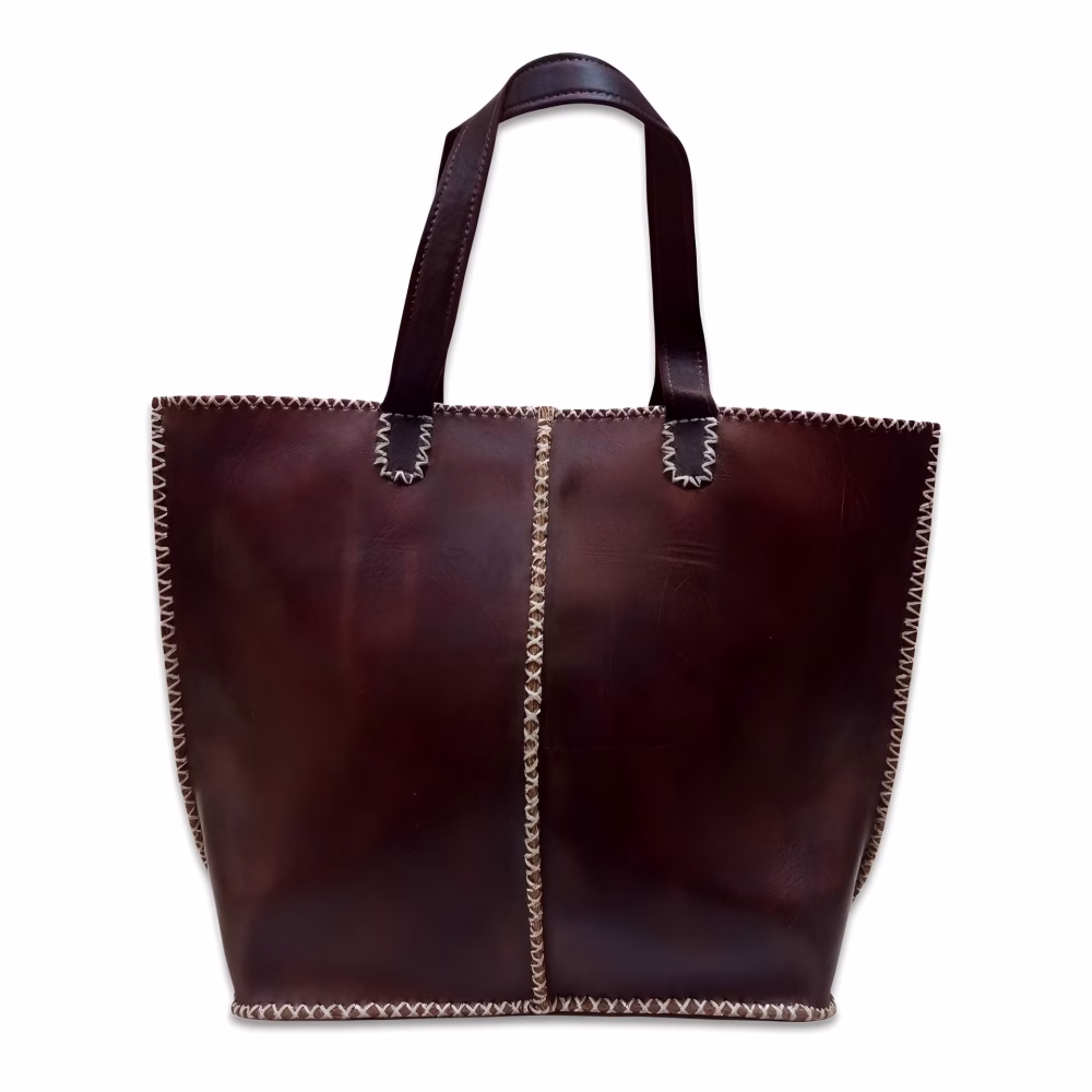 Product photo of dark brown leather tote bag against white background