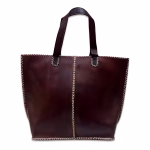Product photo of dark brown leather tote bag against white background