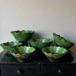 Tamegroute ceramic bowls set arranged on black cabinet displaying handcrafted artisan pottery